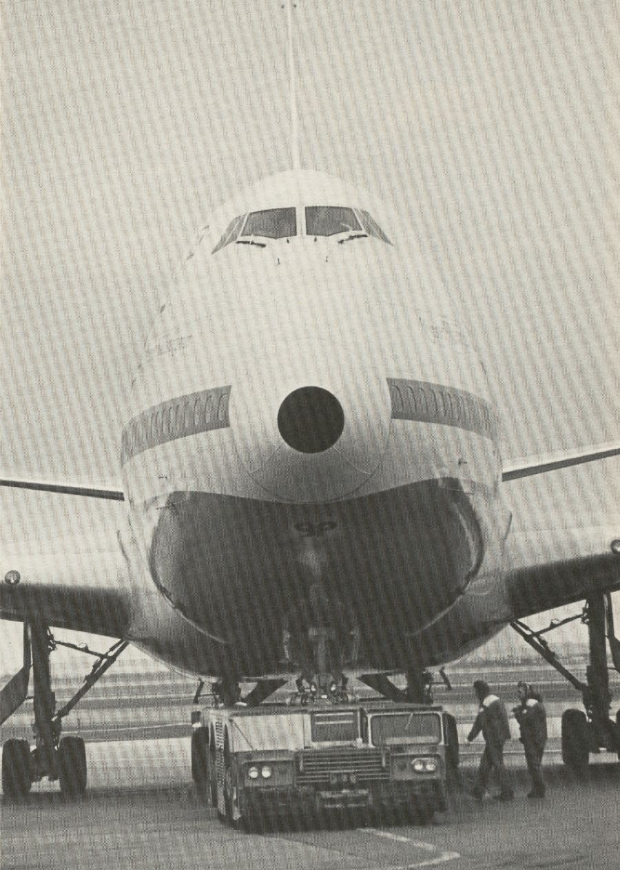 1981 A Pan Am 747 is being 'pushed back' from a gate.  A powerful tug was needed to move a fully loaded 747.